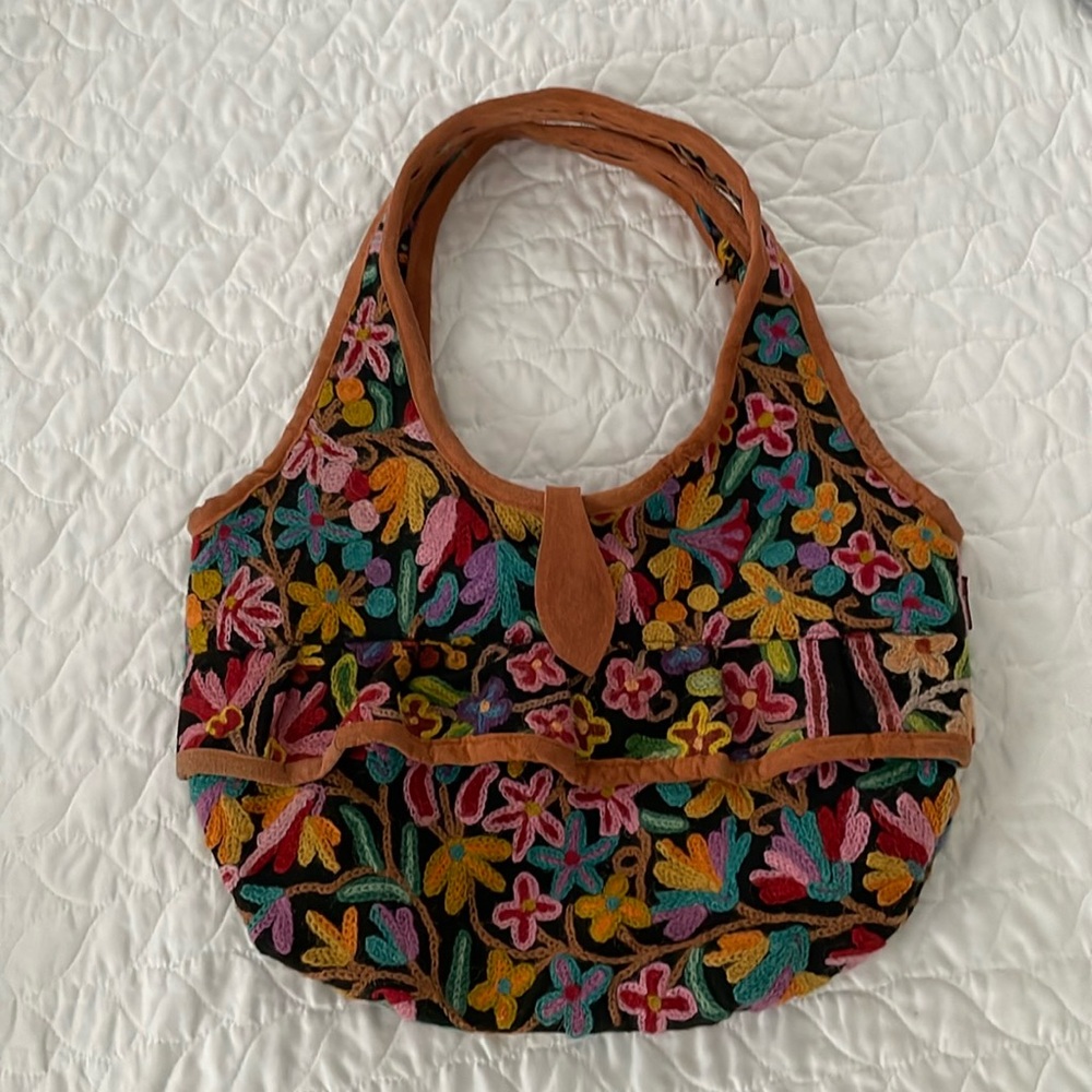 Hand embroidered, zip enclosure. One of a kind bought in Paris at a artisan shop